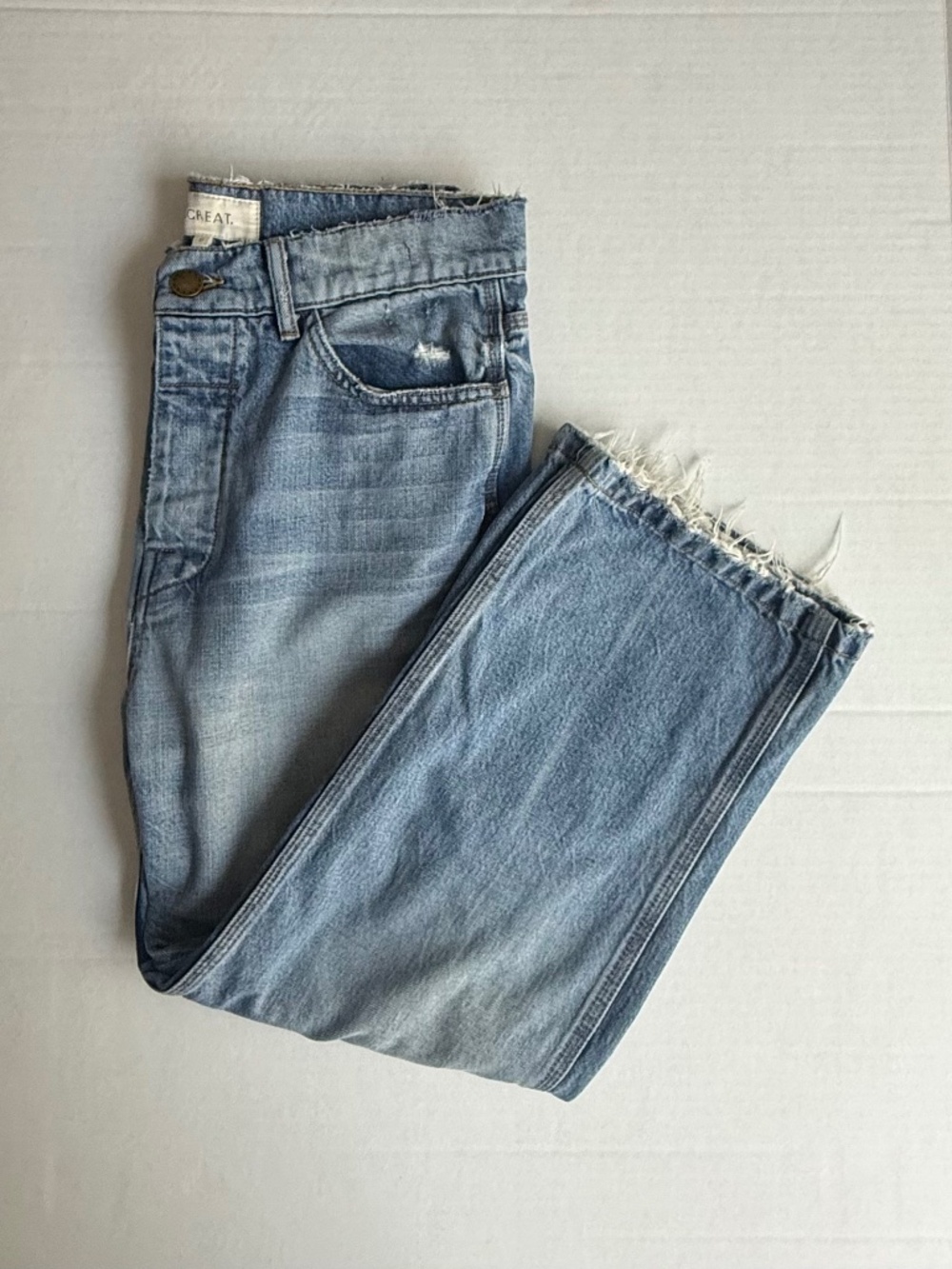 THE GREAT. Light Wash Distressed Cropped Jeans